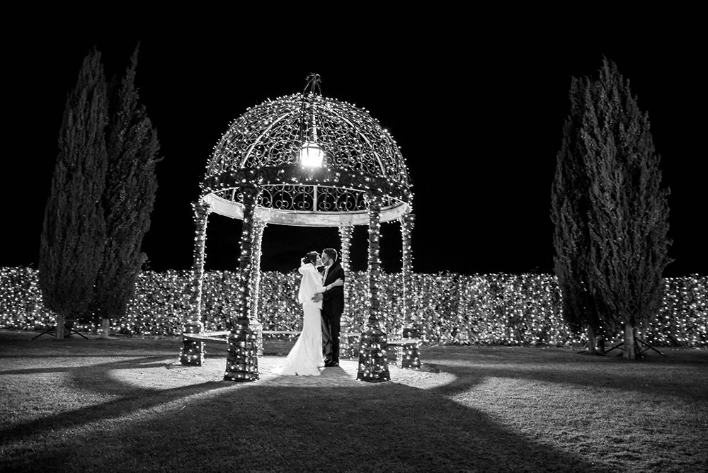 black and white late evening wedding ceremony in London under a pagoda decorated with twinkly lights