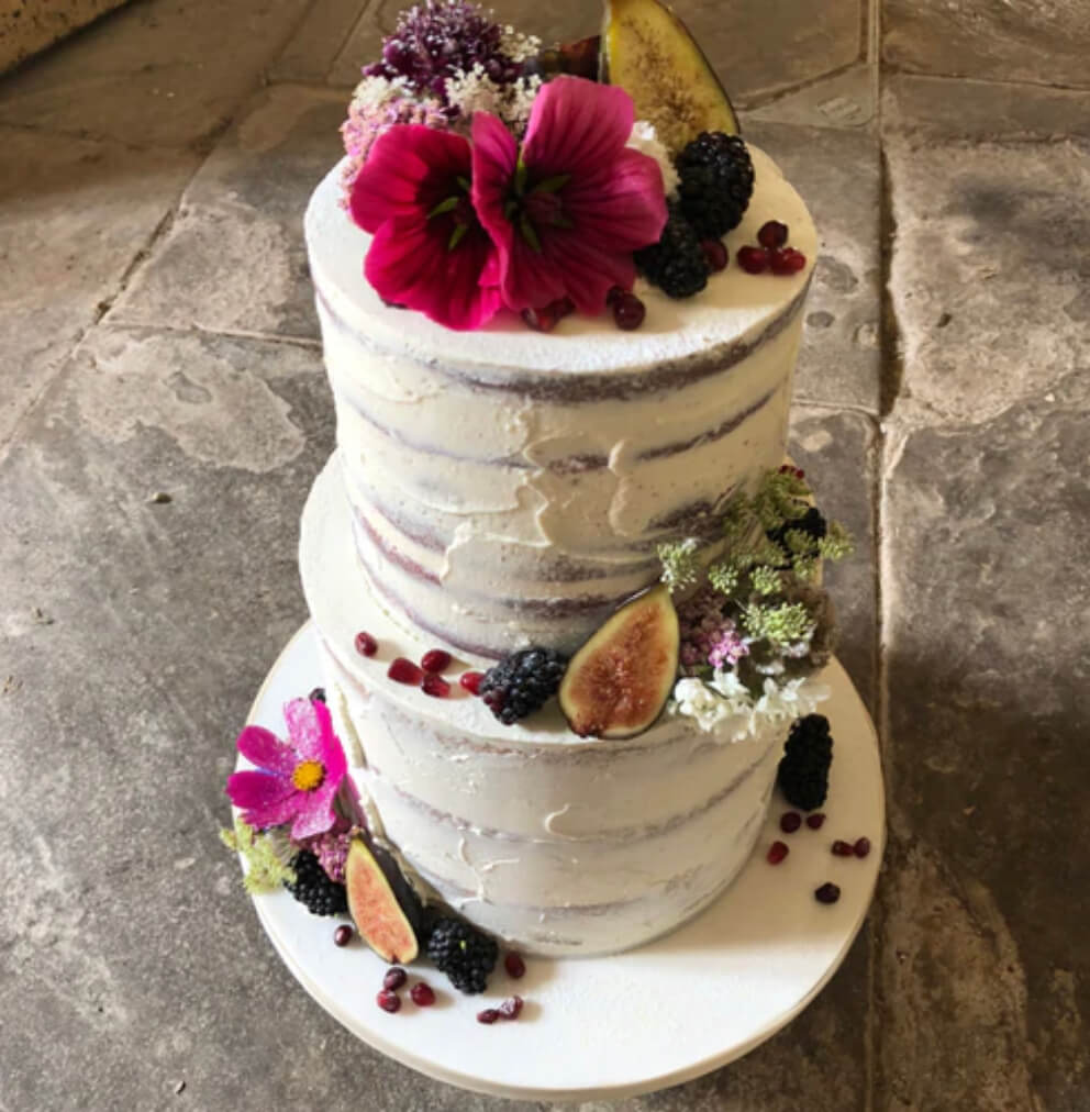semi naked luxury wedding cake with pink florals and figs Cotswolds vanilla pod bakery - luxury wedding cake designer