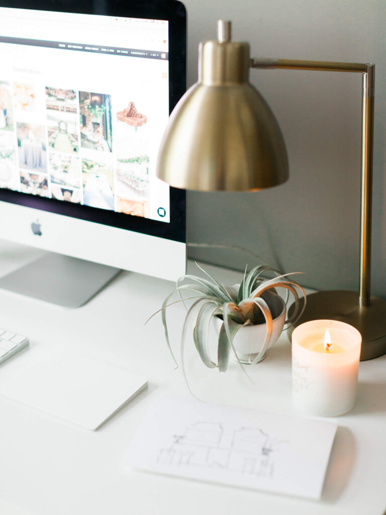 a desktop, succulent plant, a lamp and a candle