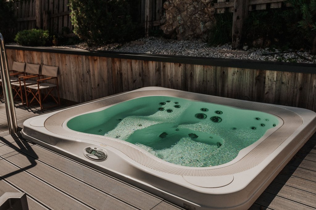 multi place jacuzzi in outdoor wooden deck