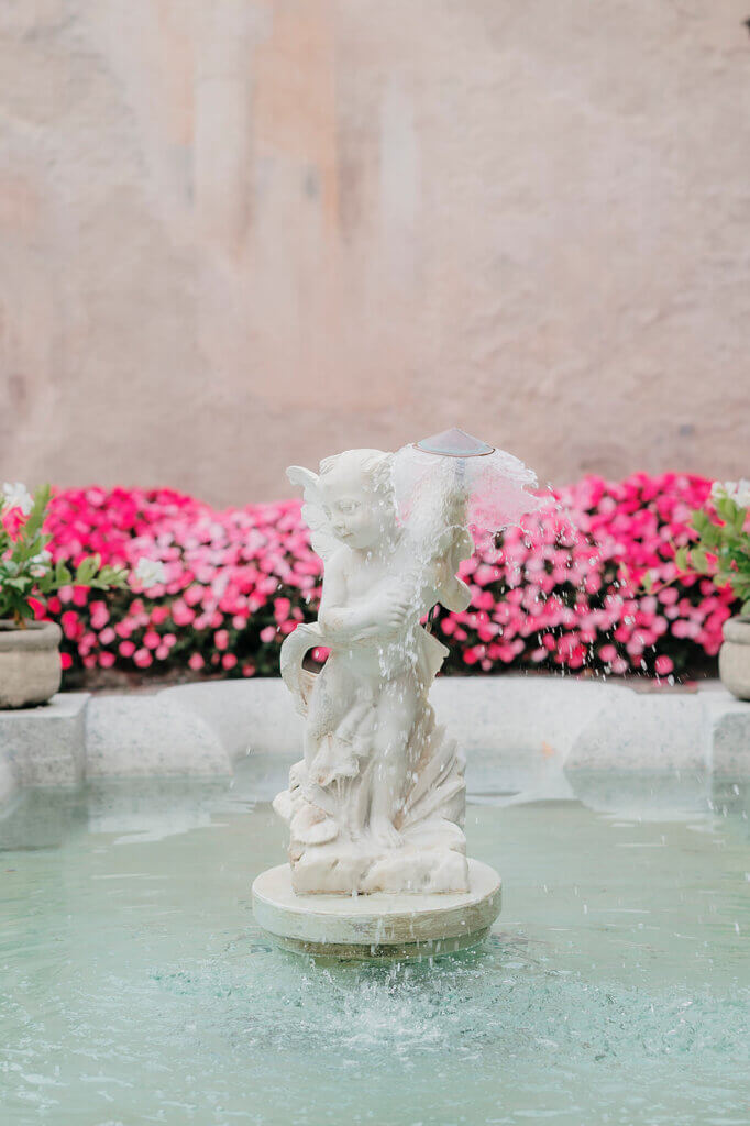 Villa Cipressi terrace fountain with cherub and pink flowrs behind it- Lake Como wedding planner