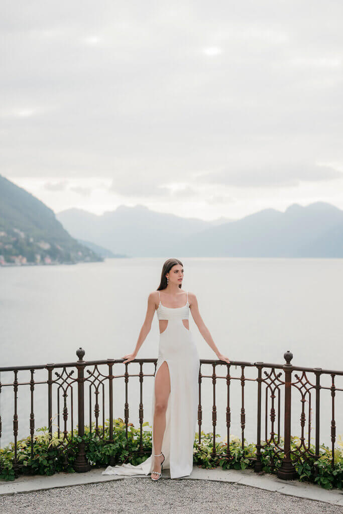 Villa Cipressi wedding bride posingon terrace overlooking the water- Lake Como wedding planner