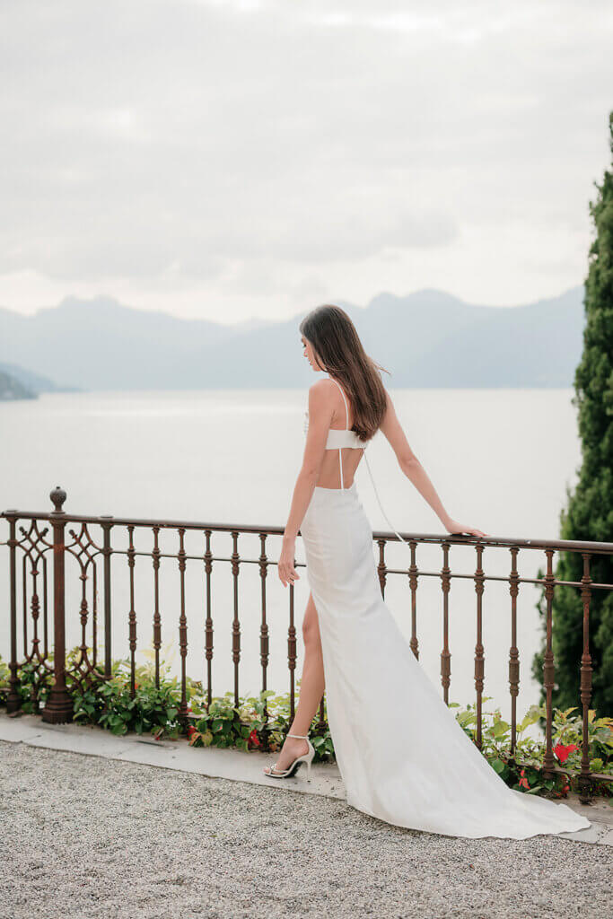 Villa Cipressi wedding bride strolling on terrace overlooking the water- Lake Como wedding planner