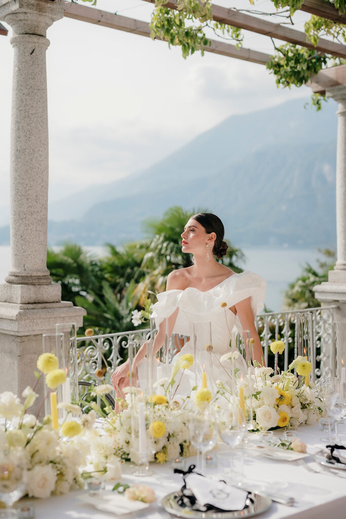 Villa Cipressi - Lake Como wedding planner bride standing behind wedding table looking at the lake