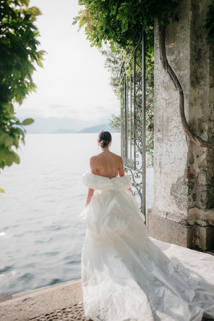 Villa Cipressi gated pier with bride overlooking water- Lake Como wedding planner